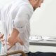 Men holding his back due to pain
